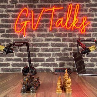 Orange Custom Neon® podcast sign on brick wall @gv_talks