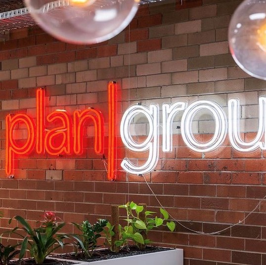 Red & white company logo sign @plangroup_australia @capture_real_estate