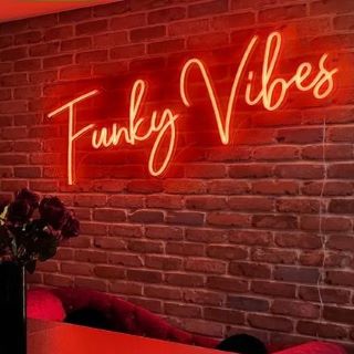 Funky Vibes red Custom Neon® kitchen sign on brick wall