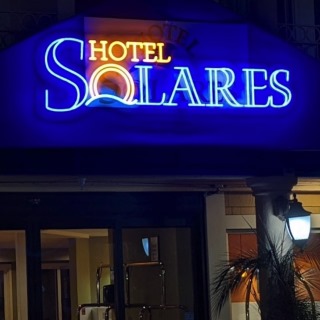 Custom Neon® outdoor waterproof sign above the entrance to hotelsolares.com