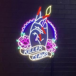 @killerclawssalon logo on black brick wall made by Custom Neon® 