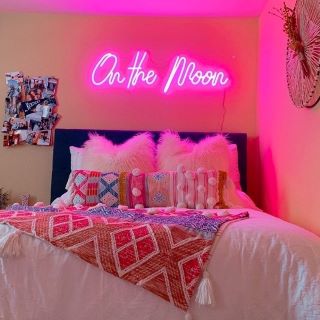 Custom Neon® pink On The Moon sign above a bed @malloryonthemoon
