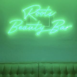 Green Custom Neon® logo @roots_beautybar