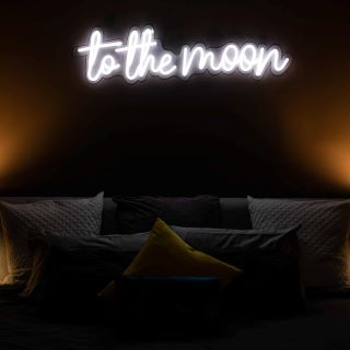 Pink Custom Neon® To the Moon sign above a bed