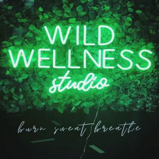 Green fitness studio window sign by Custom Neon® for @wildwellnessstudio