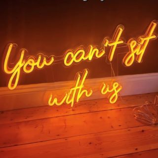 You Can't Sit With Us orange Custom Neon® word sign