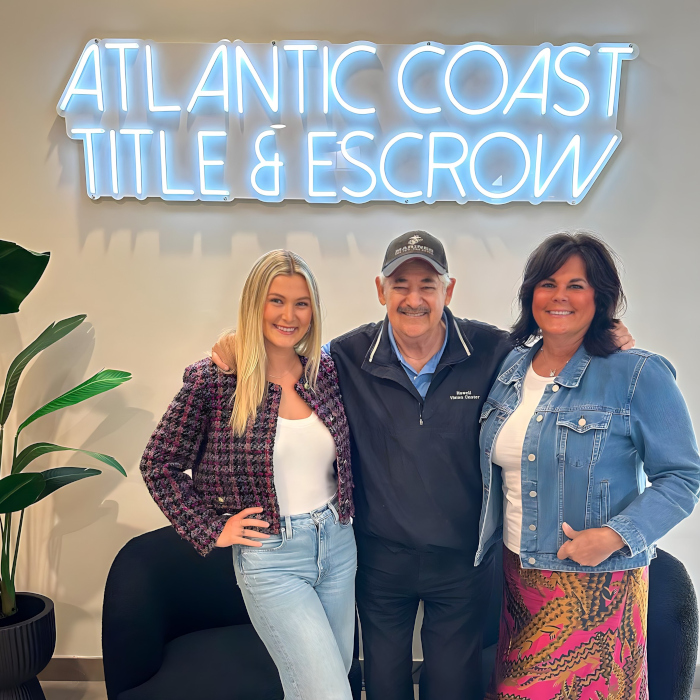 White Custom Neon® realtor sign on white office wall @actitleescrow
