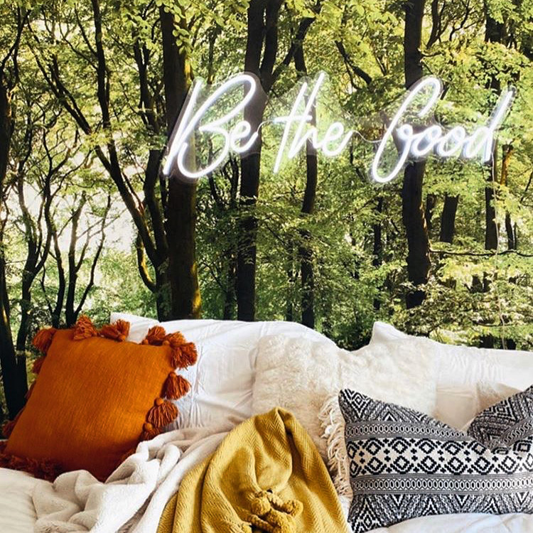White 'Be The Good' neon word sign in living room @construction2style by Custom Neon®