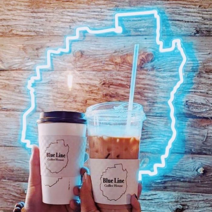 Custom Neon® blue line logo on the exterior of Blue Line Coffee House above the entrance