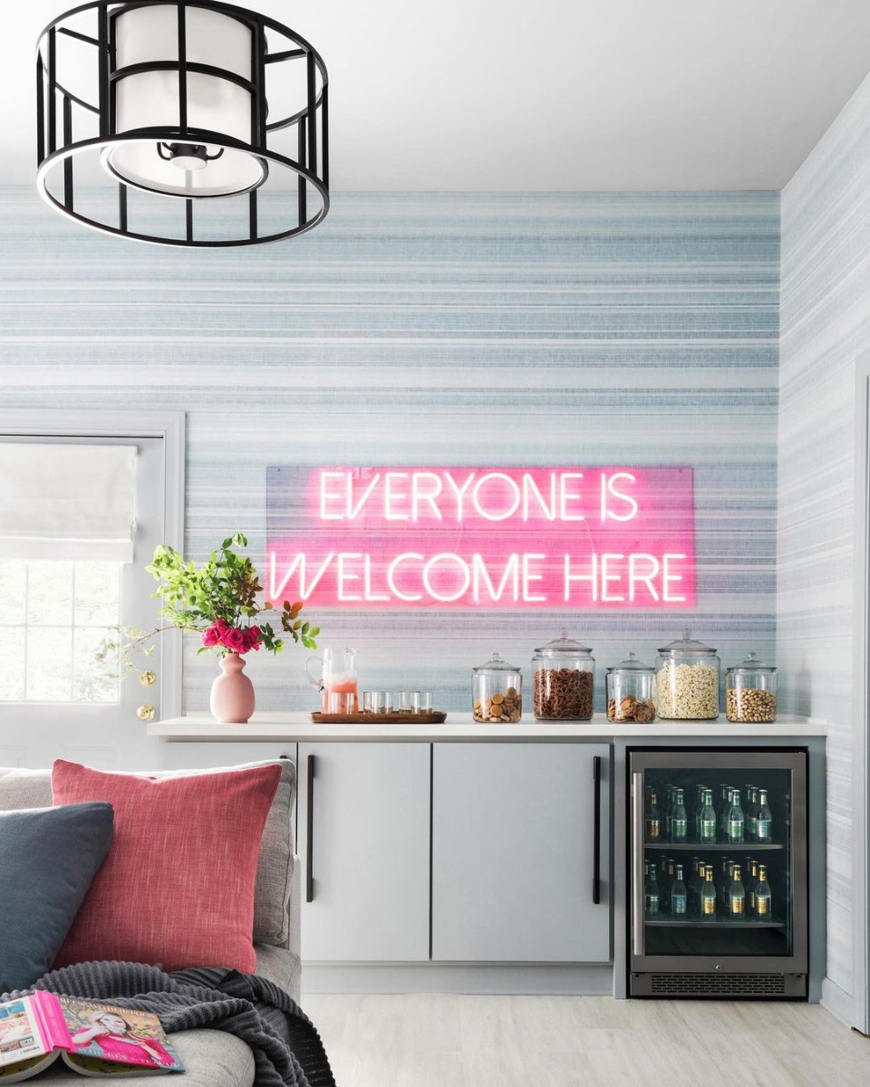 Custom Neon® Everyone Is Welcome Here light red sign in teen hideout designed by @bpatrickflynn