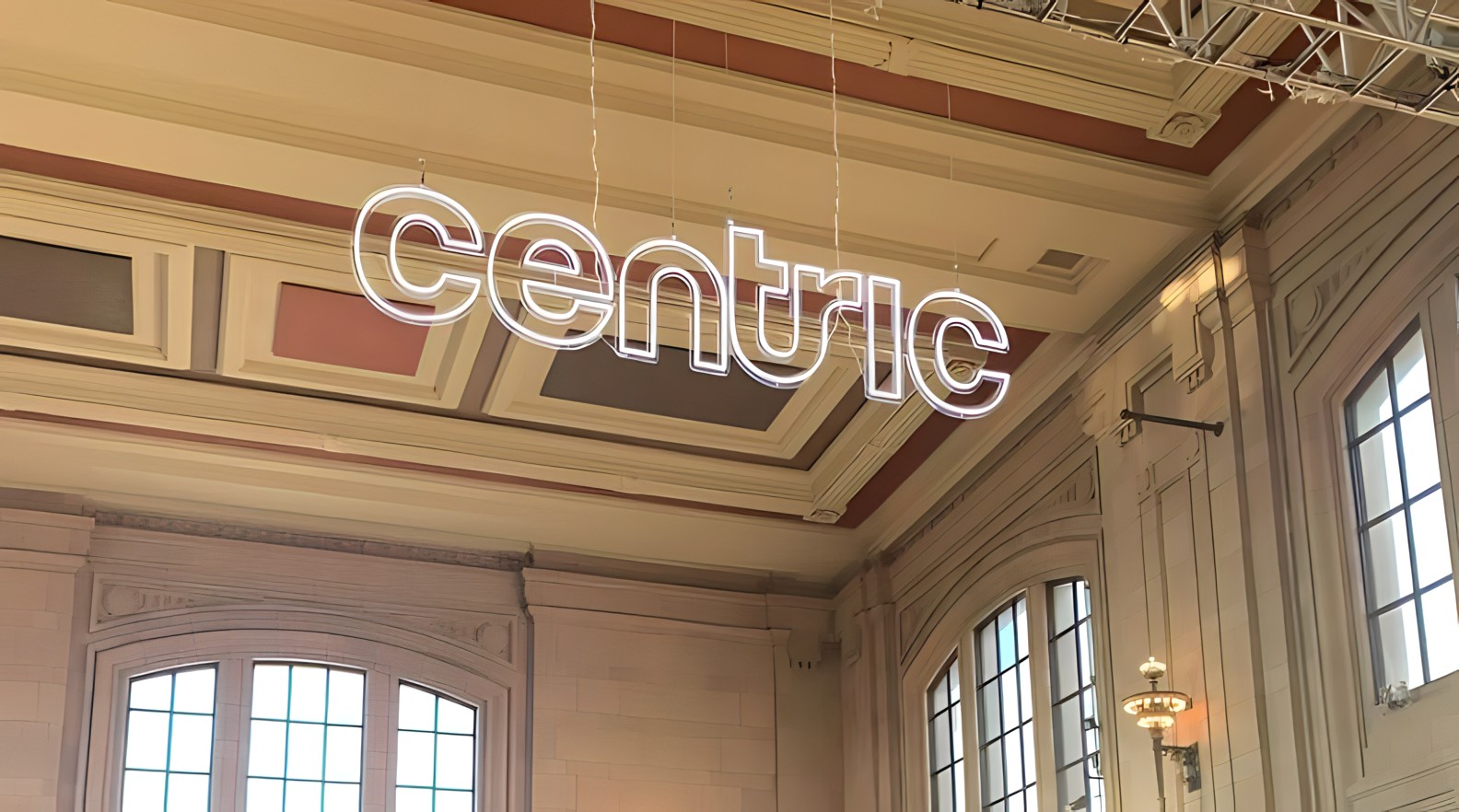 Custom Neon® white logo sign hung from the ceiling @centricbuild