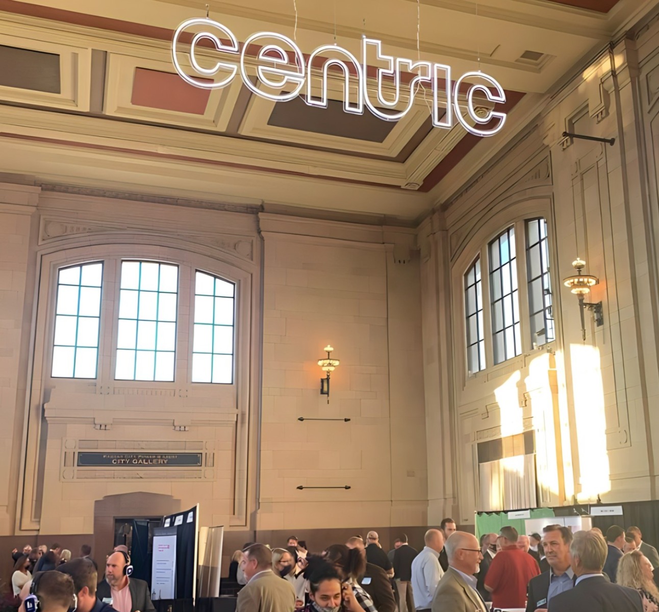 Custom Neon® white logo sign hung from the ceiling @centricbuild