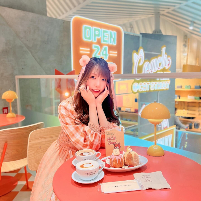 Custom Neon® signs in background of a selfie sign taken in the Coach Café at Coach Play @Cat Street @coach_japan photo by @shi0tann