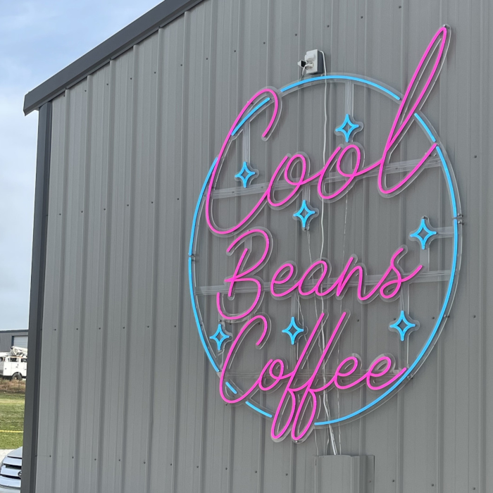 Pink & blue coffee retailer logo sign by Custom Neon® on the exterior of the building @coolbeanscoffee