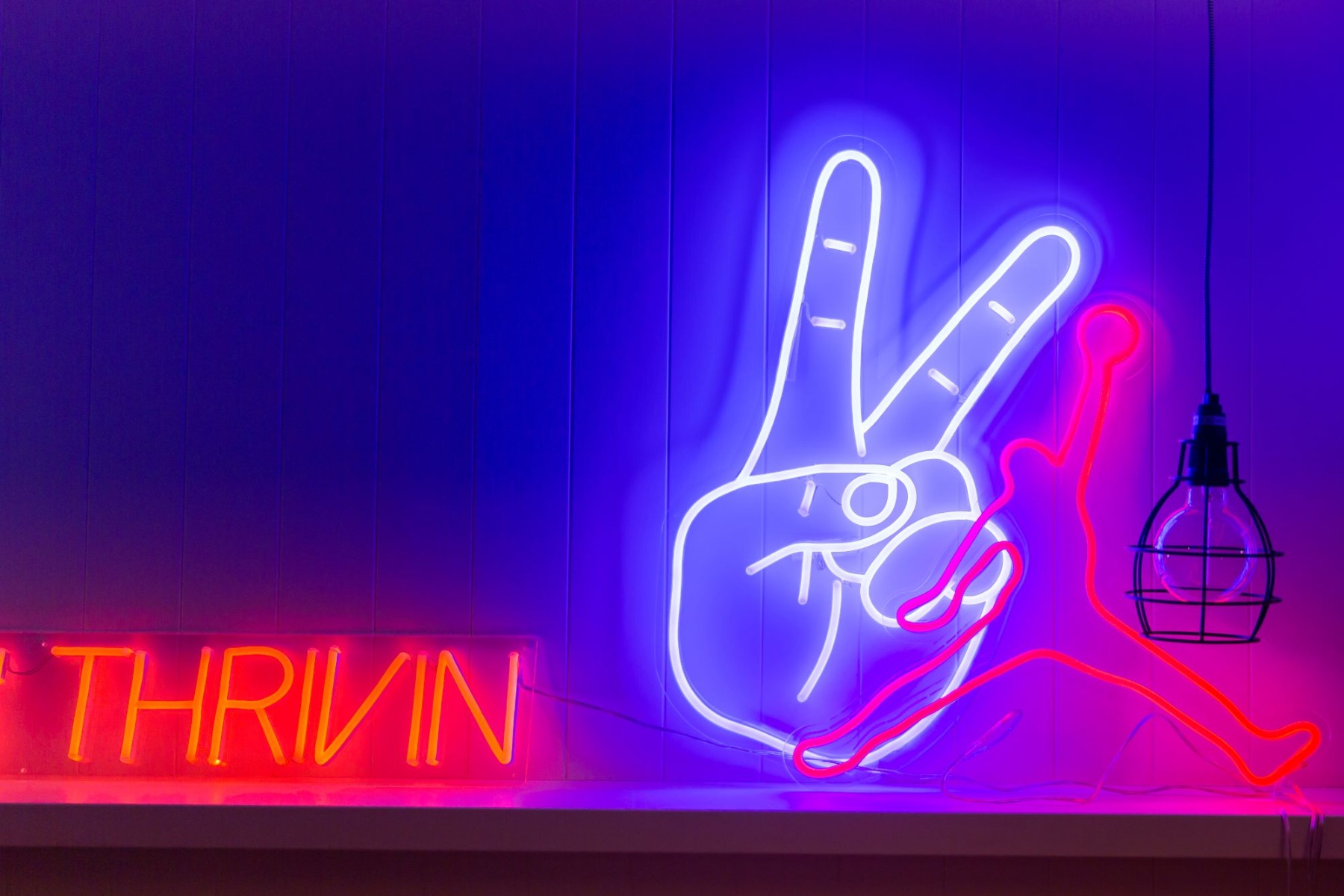 Custom Neon® peace sign and basketball player wall art