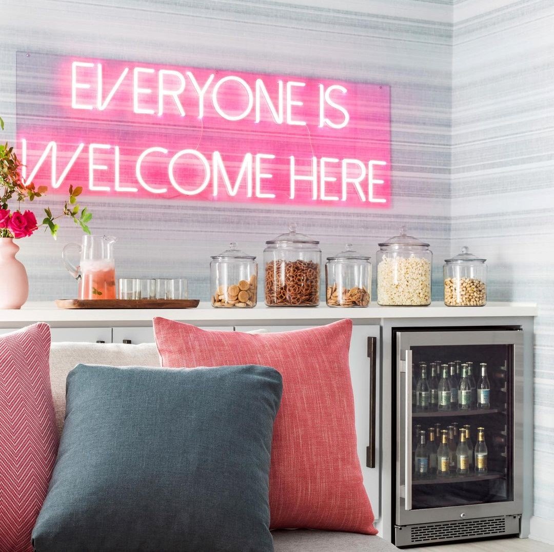 Custom Neon® Everyone Is Welcome Here light red sign on grey wallpaper @bpatrickflynn