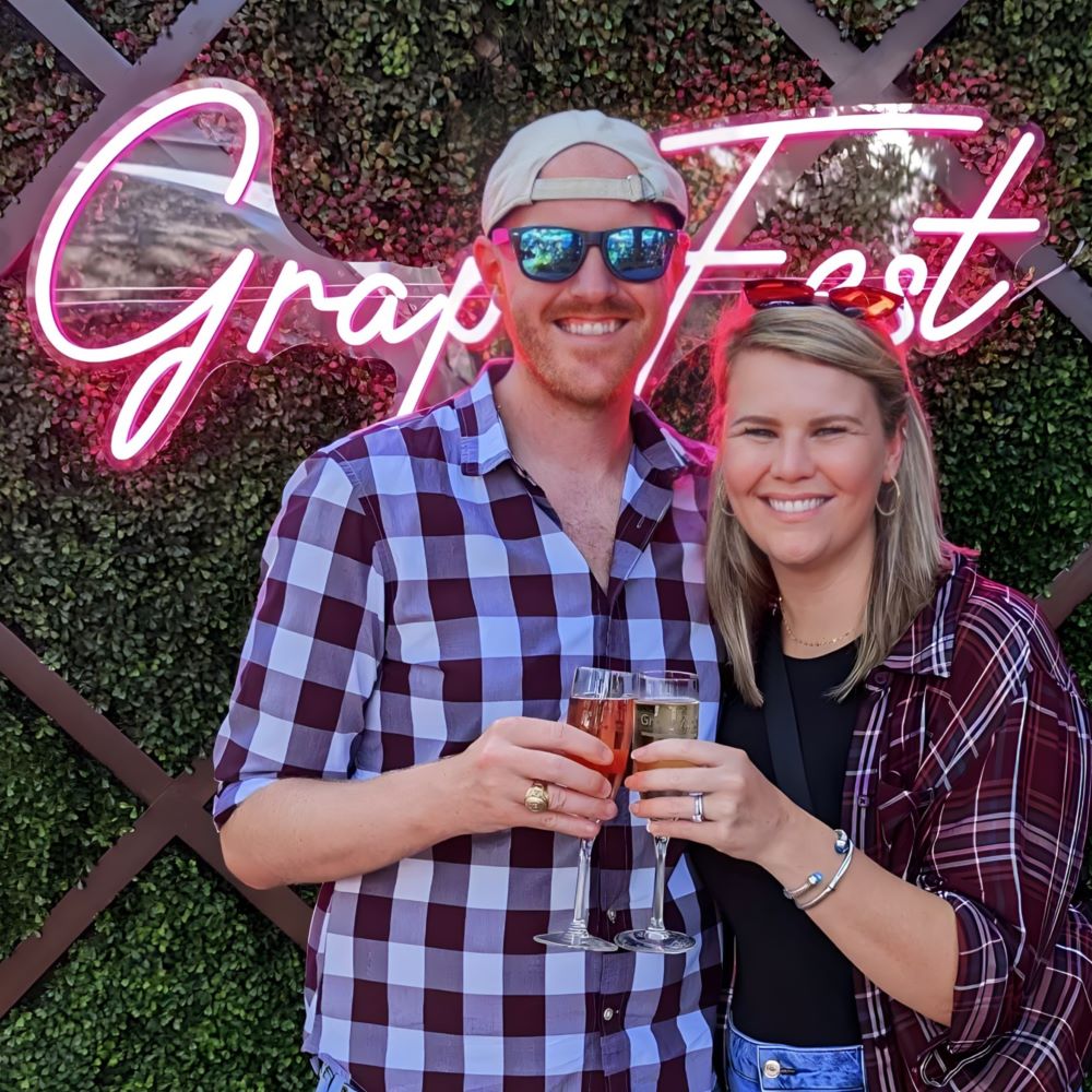 Custom Neon® selfie booth sign on greenwall @grapefest.tx
