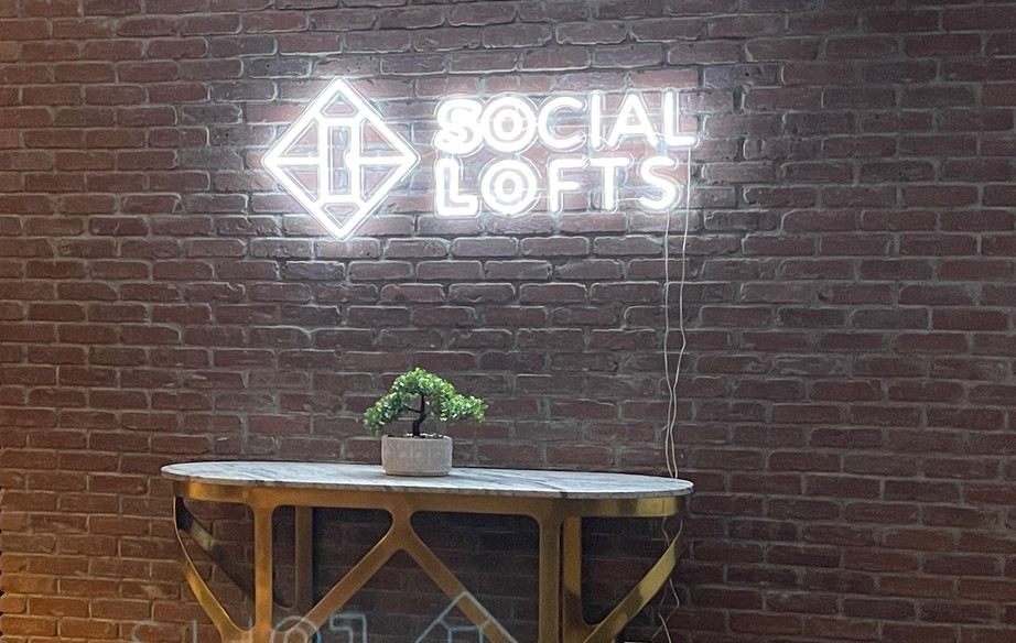 Custom Neon® white sign on brick wall housechaser.com