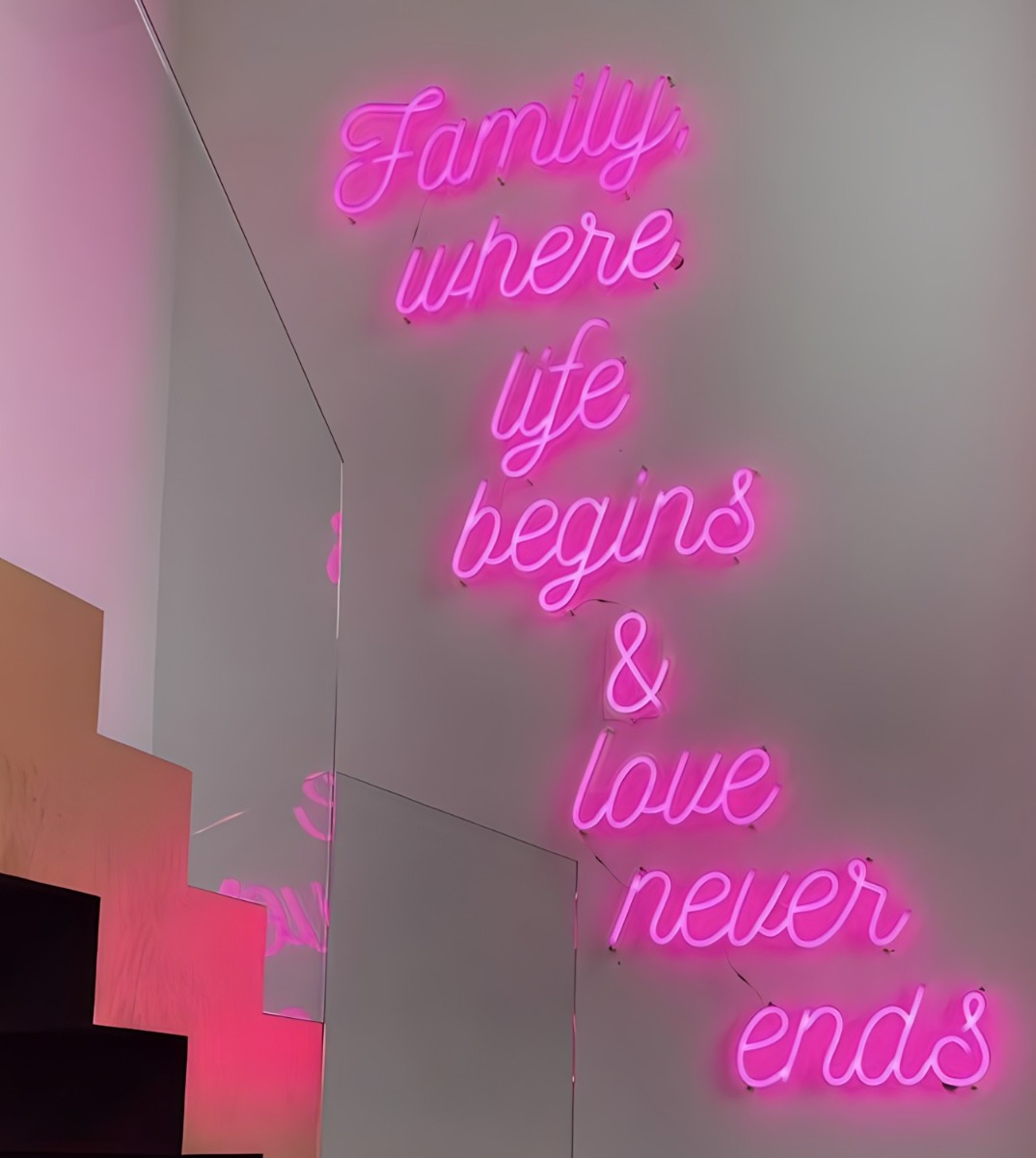 10ft high pink Custom Neon® wall sign near stairs in a home