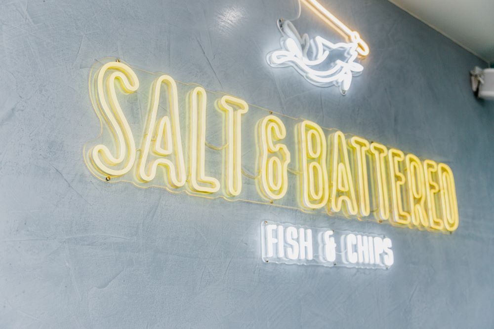 Salt & Battered color changing Custom Neon® RGB sign on yellow