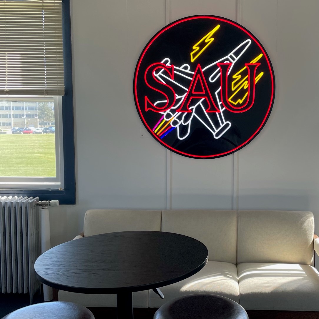 Custom Neon® multi-colored round sign on black backing