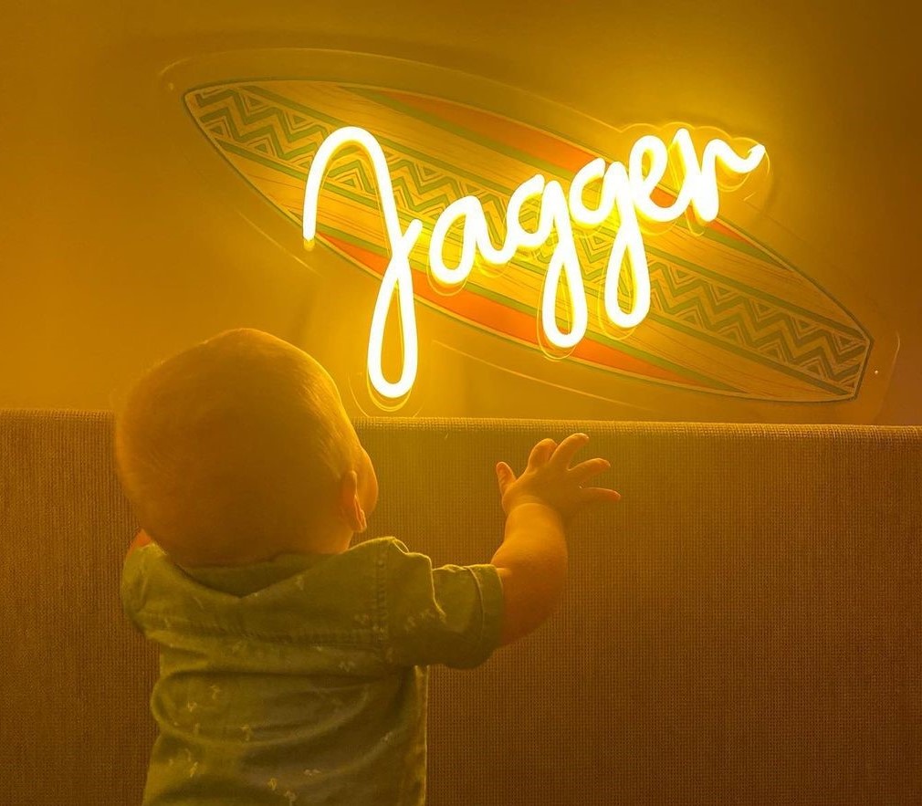 Custom Neon® yellow UV print surfboard name sign in boys room @janamaymargo